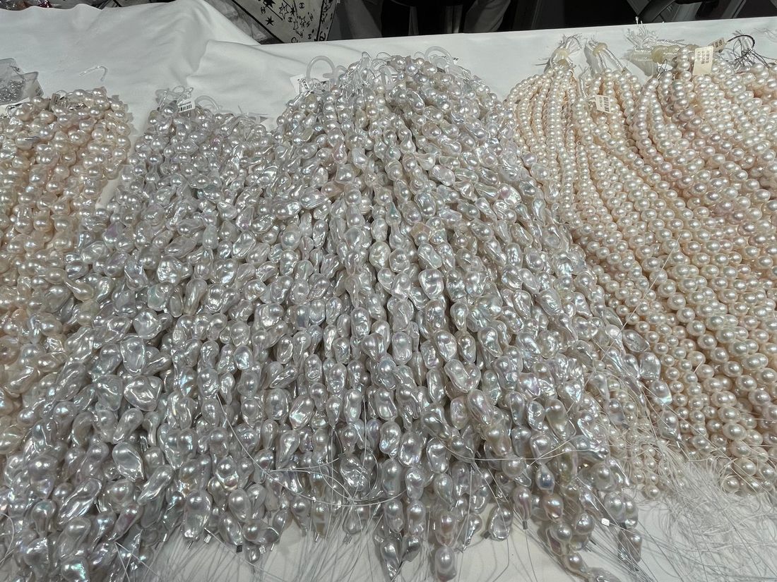 Baroque and fancy-shape freshwater pearl strands sorted by hand on a table